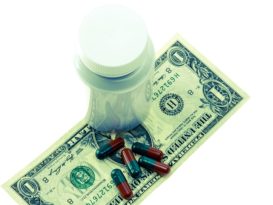 Healthcare Reimbursment can be costly: Pill bottle with money